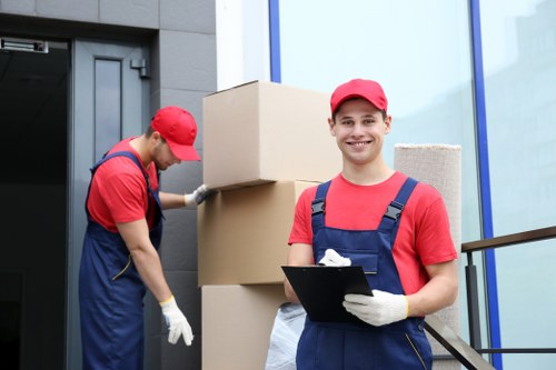 Professional movers carrying furniture carefully through a property