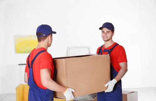 Removal team preparing for safe lifting and packing during a move