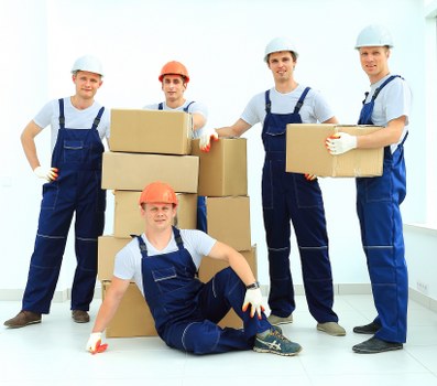 Trained movers using PPE while handling furniture