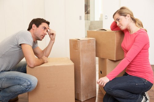 Professional movers handling furniture carefully in a London property